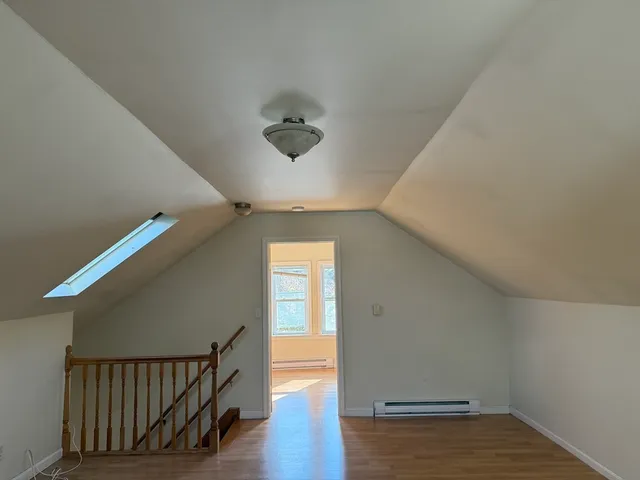 a view of an entryway with wooden floor