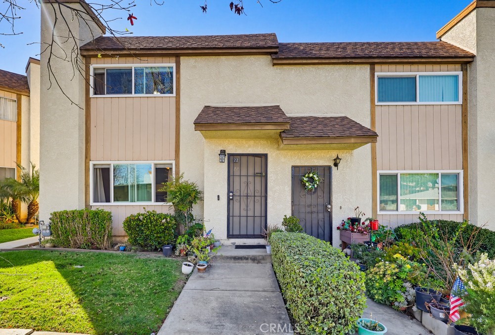 a front view of a house with garden