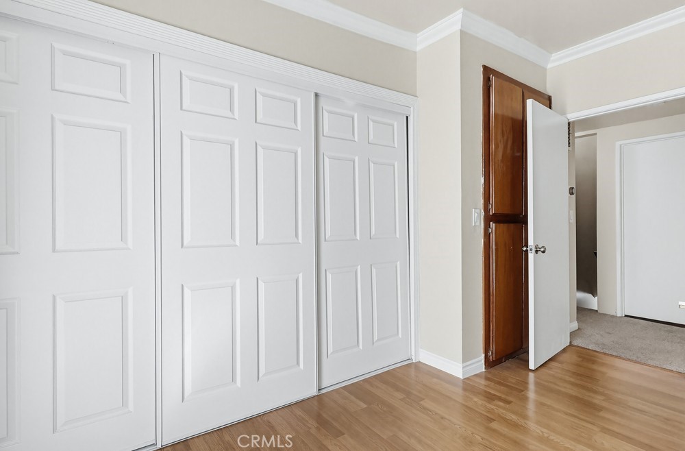 13470 Meyer Road, Unit 22 Whittier, CA 90605 - Photo 29 of 50 an empty room with wooden floor windows and closet area