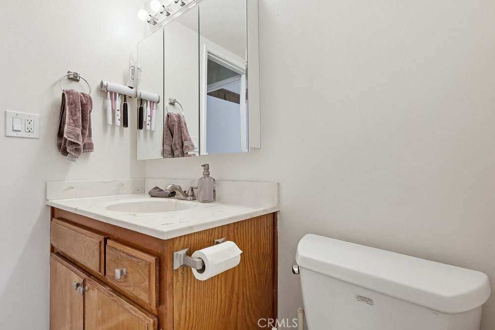 13470 Meyer Road, Unit 22 Whittier, CA 90605 - Photo 31 of 50 a bathroom with a sink a toilet and vanity
