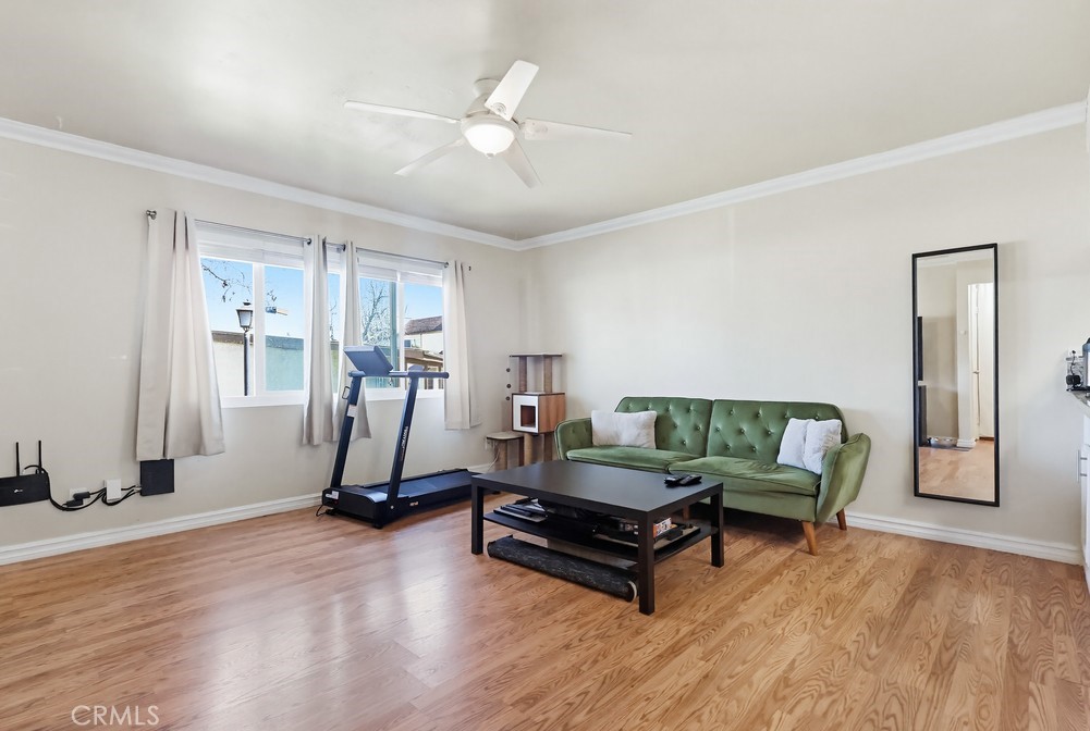 13470 Meyer Road, Unit 22 Whittier, CA 90605 - Photo 10 of 50 a living room with furniture gym equipment and a window