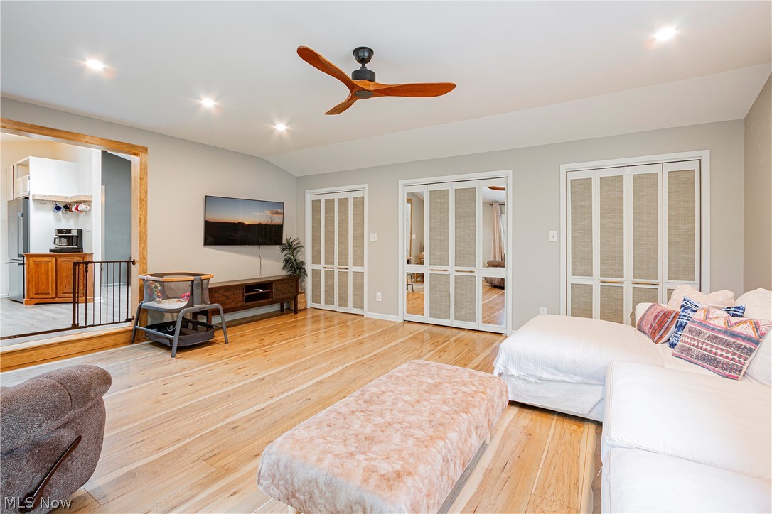 9315 Price Road Ravenna, OH 44266 - Photo 19 of 31 Luxury Vinyl Wood flooring with ceiling fan and a full wall of closets for storage