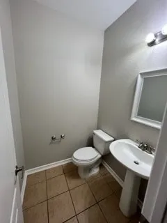 an empty room with windows and chandelier fan