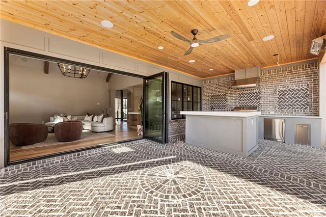 a dining room with wooden floor a chandelier a wooden table and chairs