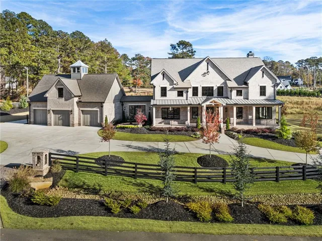an aerial view of a house with swimming pool garden and patio