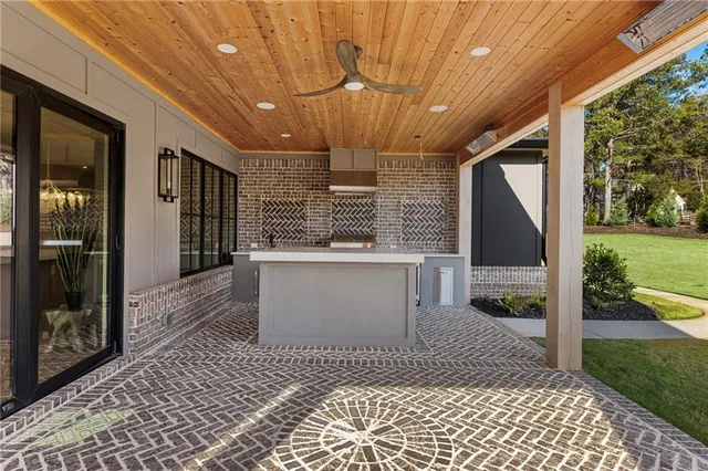 a kitchen with stainless steel appliances granite countertop a sink stove and cabinets