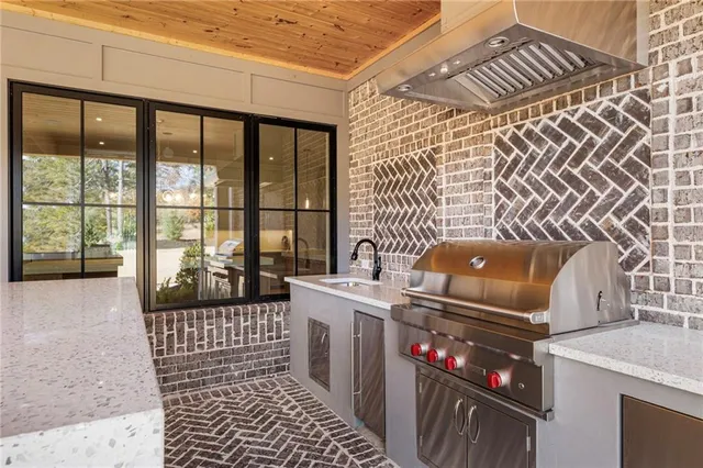 a kitchen with stainless steel appliances a sink a counter top space and cabinets