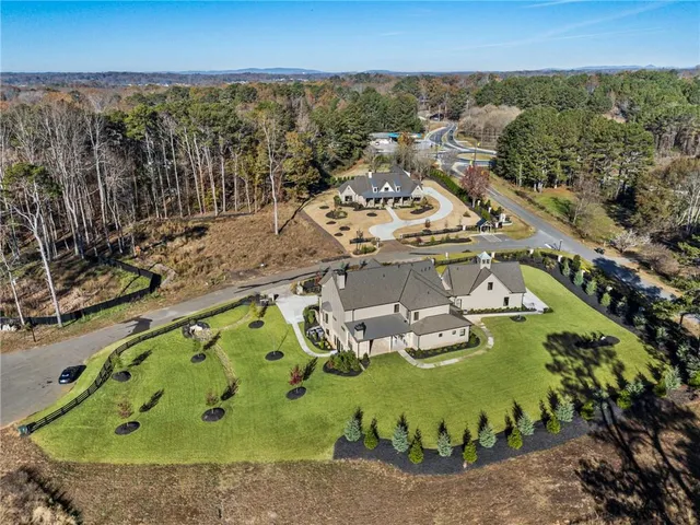 a living room with furniture fireplace and a large window