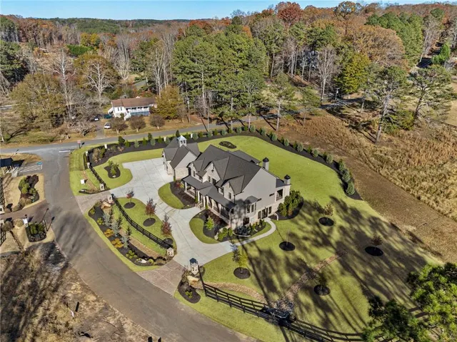 a view of a hallway with wooden floor and a living room