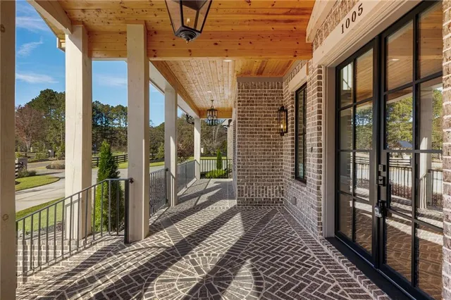 a view of an empty room and window and wooden floor