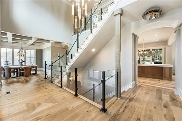a view of a kitchen with kitchen island a sink stainless steel appliances and cabinets