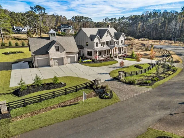 a view of a chair and table in backyard of the house