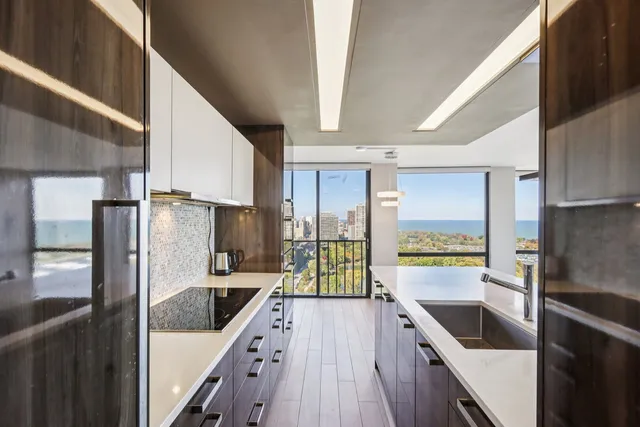 a kitchen with a refrigerator a sink and wooden cabinets