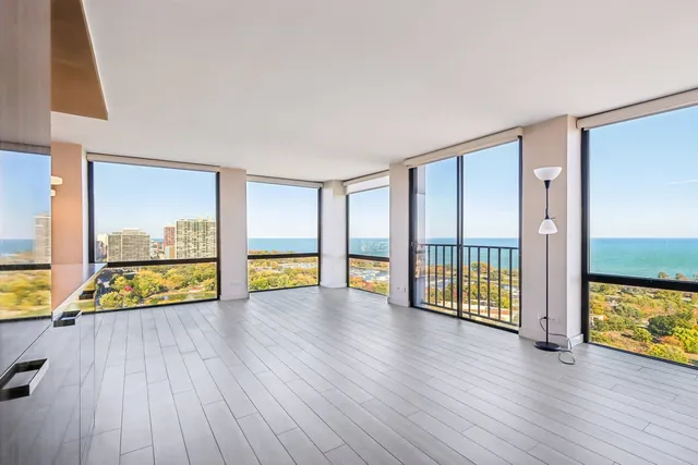 a view of an empty room window and wooden floor