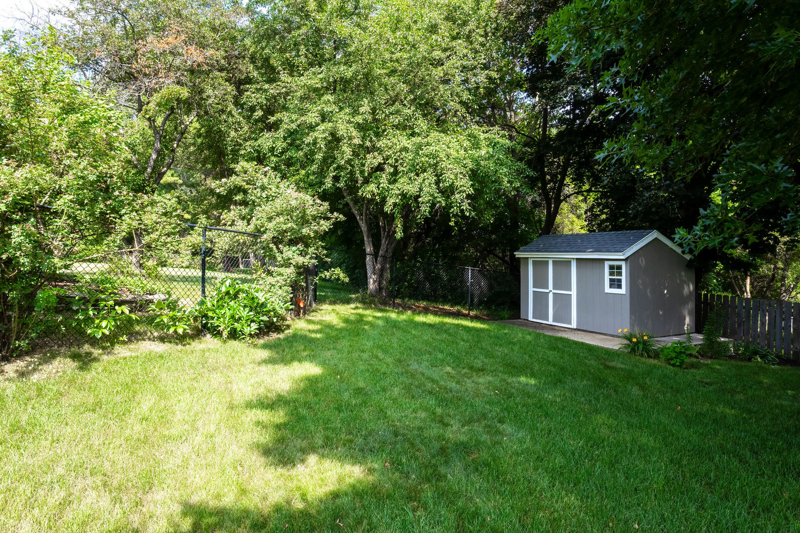 4314 Spring Street Davenport, IA 52807 - Photo 48 of 51 a view of a big yard with plants and large trees