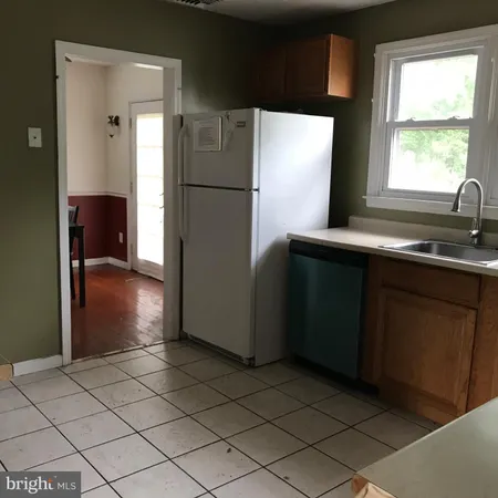 a kitchen with a refrigerator and a sink