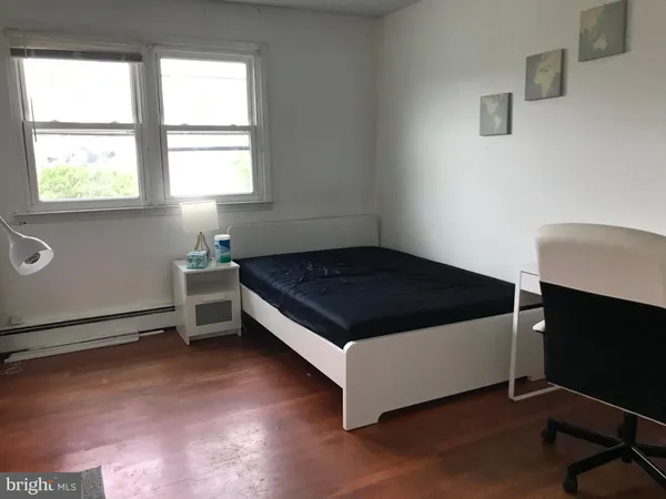 a bed sitting in a bedroom next to a window