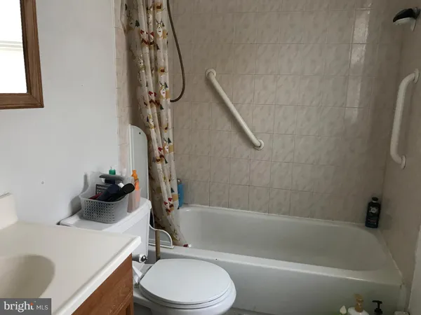a bathroom with a sink a toilet and bathtub