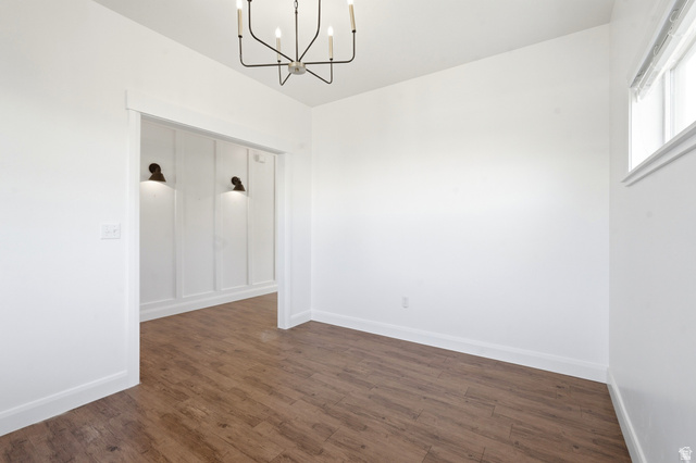 338 Windy Rdg Drive Smithfield, UT 84335 - Photo 10 of 63 Expansive room featuring wood-finish flooring, a contemporary chandelier, and a window with white trim
