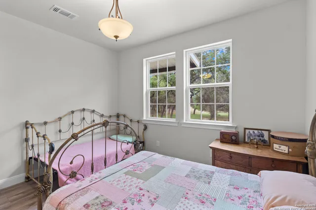 a view of a bedroom with furniture and window