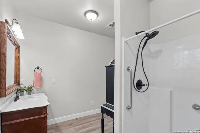a view of storage and utility room with wooden floor
