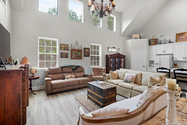 a view of an empty room with wooden floor and a book shelf