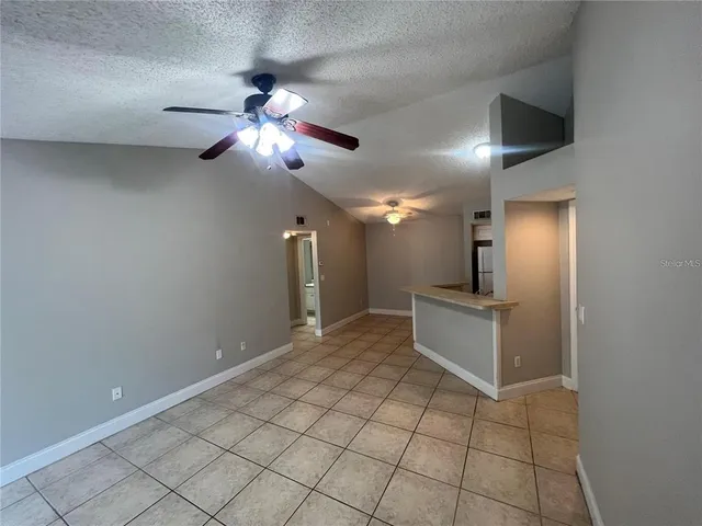 a view of a kitchen with a sink and a chandelier fan