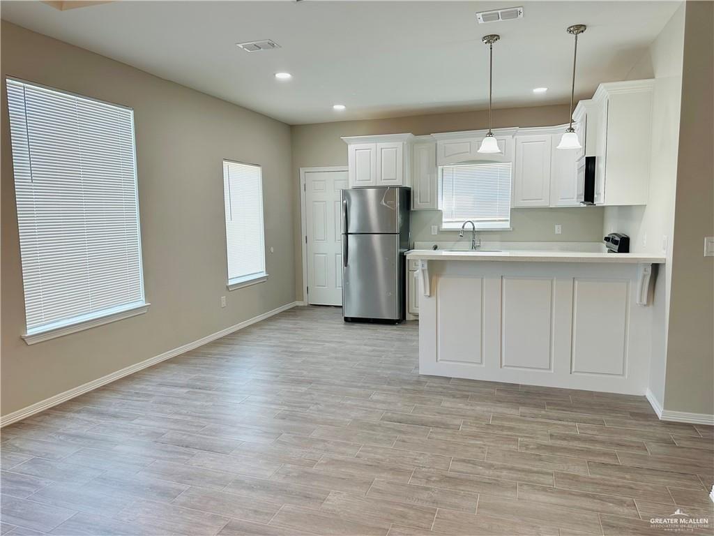 1614 Playa Drive, Unit 2 Weslaco, TX 78596 - Photo 3 of 8 a view of kitchen with stainless steel appliances granite countertop cabinets and wooden floor