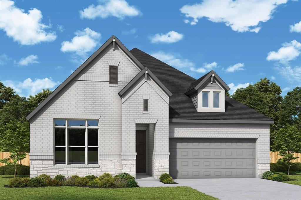 View of front of property featuring concrete driveway, stone siding, brick siding, and an attached garage