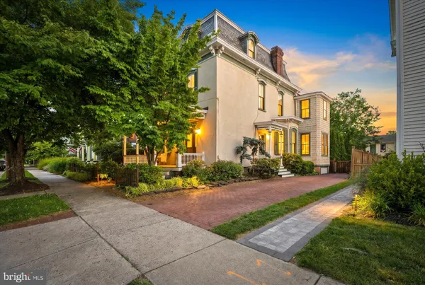 a front view of a house with a yard and outdoor seating