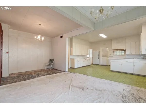 a open kitchen with kitchen island a sink stainless steel appliances and cabinets