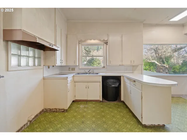 a kitchen with a sink stove and cabinets
