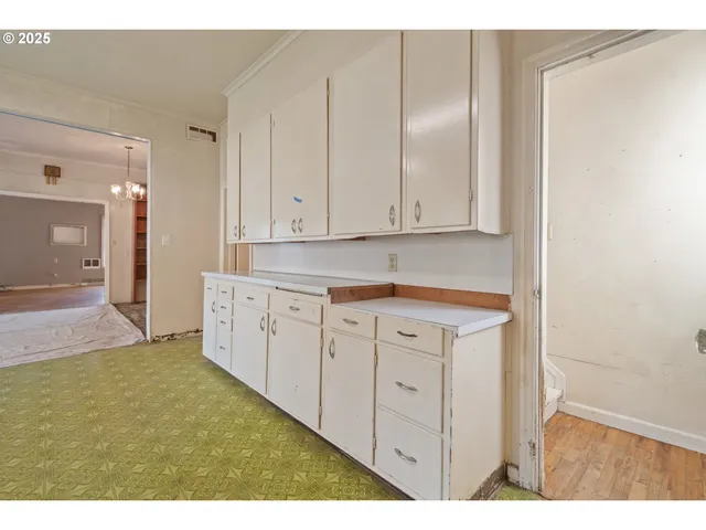 a kitchen with white cabinets