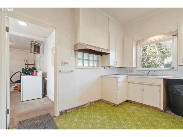 a kitchen with a sink cabinets and window
