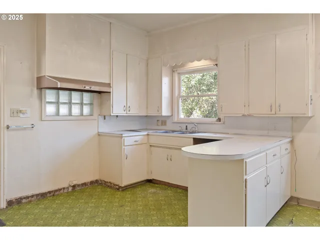 a kitchen with a sink cabinets and window