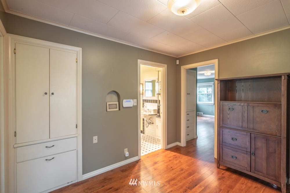 11481 Walker Road Mount Vernon, WA 98273 - Photo 16 of 38 a bedroom with a dresser and chandelier