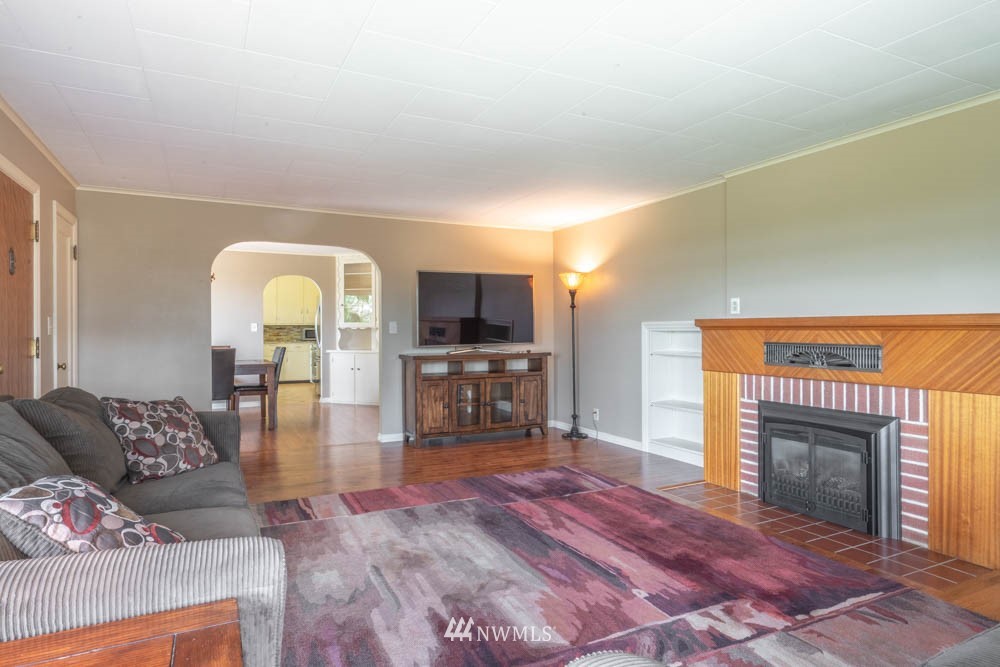 11481 Walker Road Mount Vernon, WA 98273 - Photo 9 of 38 a living room with furniture a fireplace and a flat screen tv