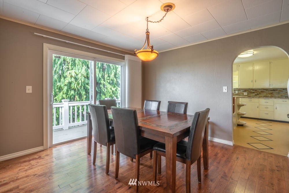 11481 Walker Road Mount Vernon, WA 98273 - Photo 10 of 38 a dining room with furniture a chandelier and wooden floor