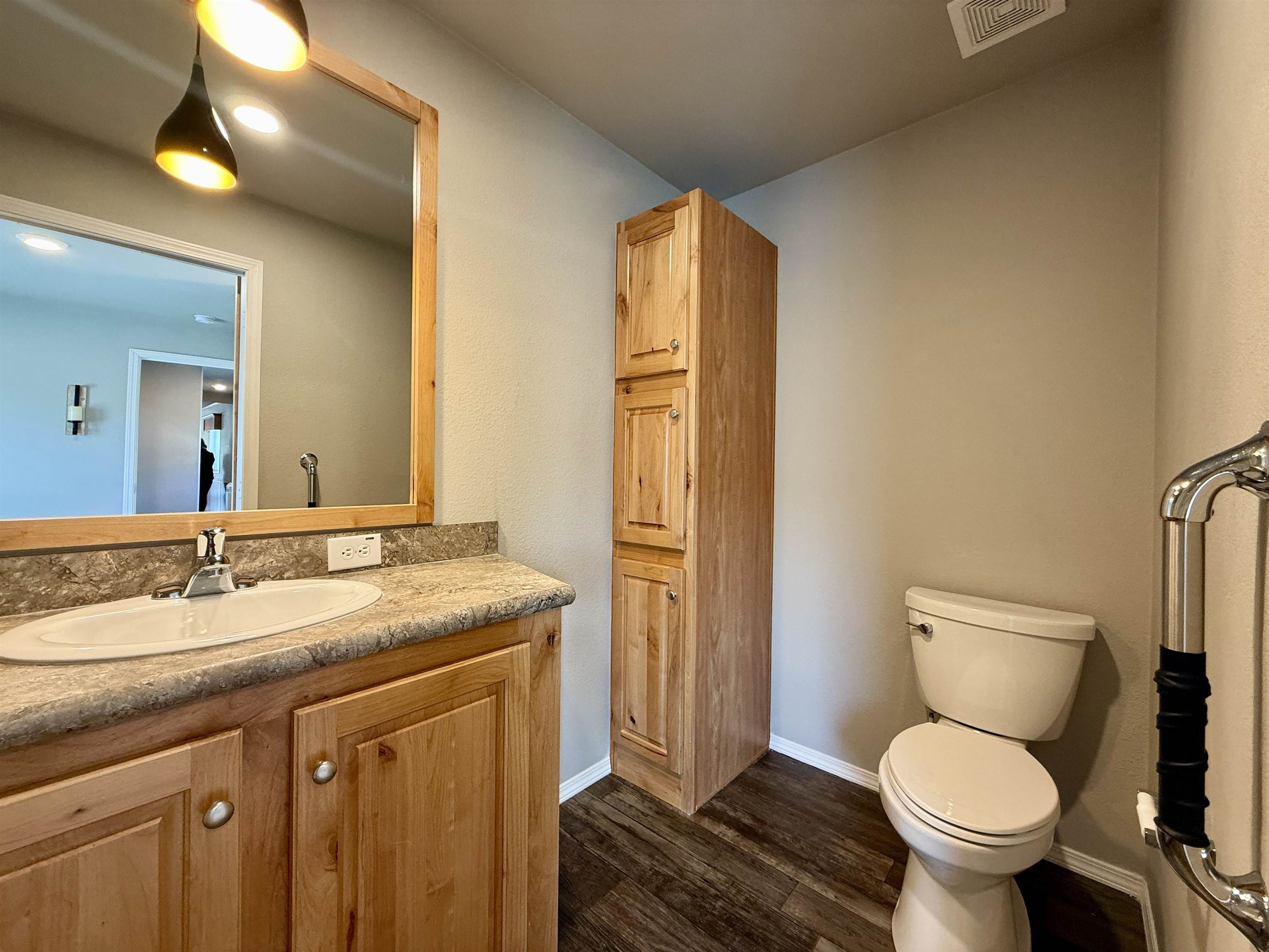435 32 Road, Unit 830 Clifton, CO 81520 - Photo 15 of 28 a bathroom with a granite countertop toilet sink and mirror