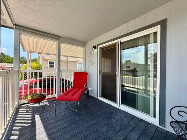 a view of a room with wooden floor and furniture