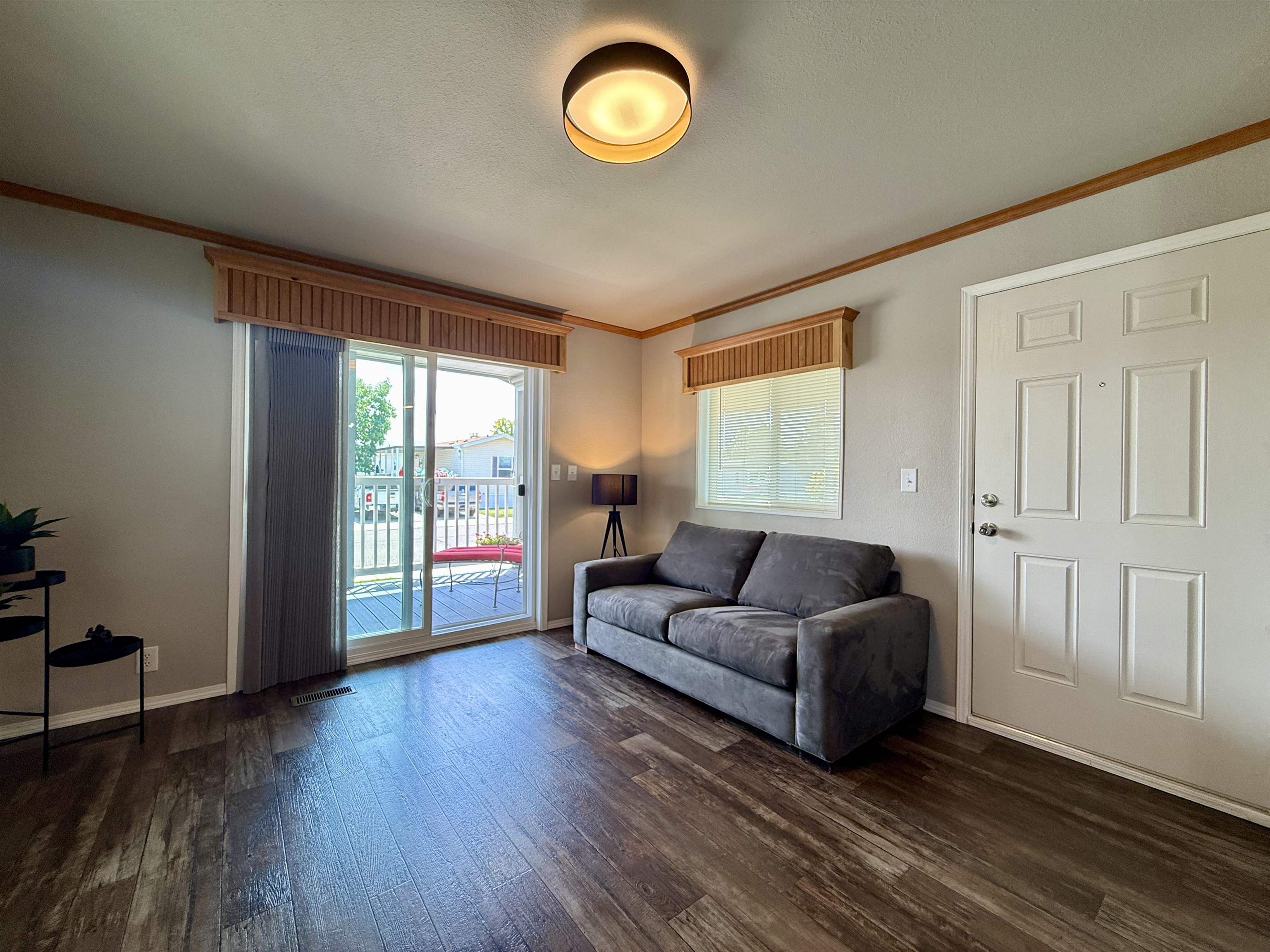 435 32 Road, Unit 830 Clifton, CO 81520 - Photo 6 of 28 a living room with couches and a large window with wooden floor