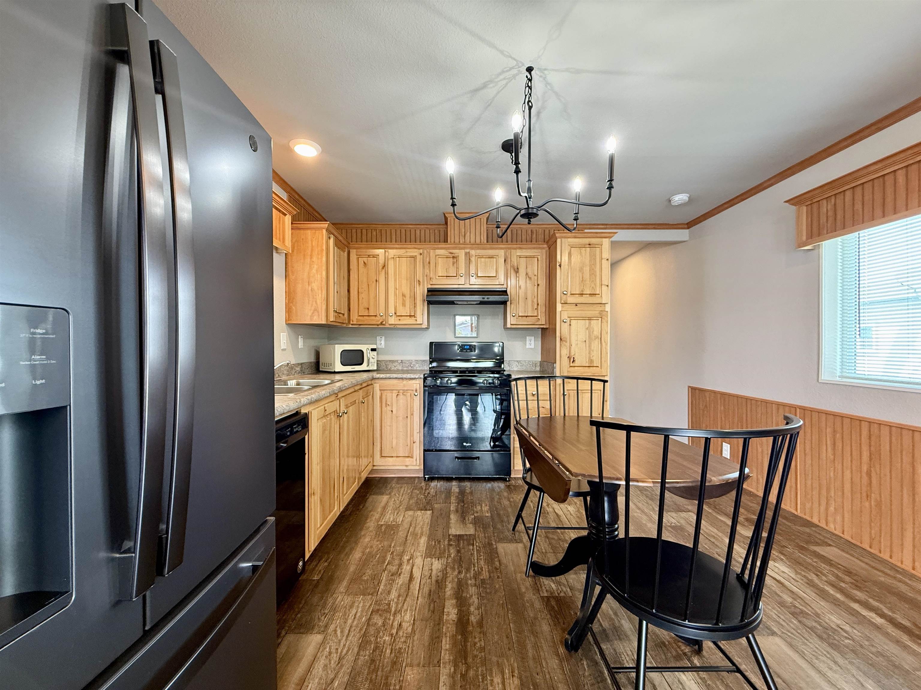435 32 Road, Unit 830 Clifton, CO 81520 - Photo 9 of 28 a kitchen with granite countertop stainless steel appliances a dining table chairs refrigerator and sink
