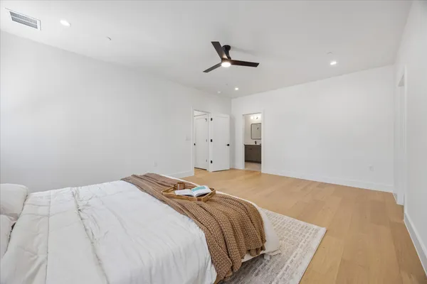 a bathroom with a double vanity sink mirror and toilet