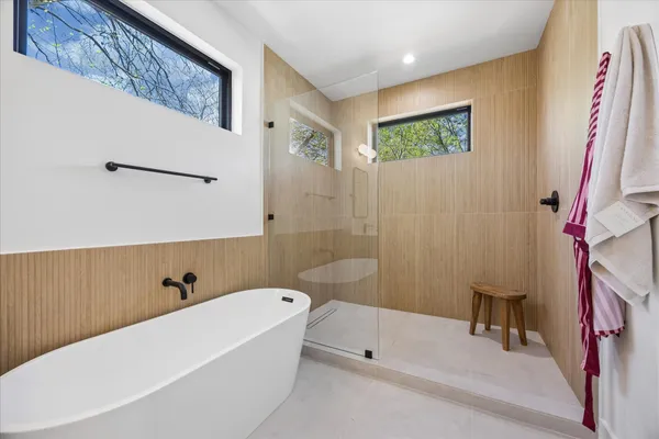 a bedroom with a bed and a potted plant on the dresser