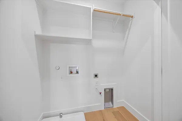 a bedroom with bed and a painting on the wall