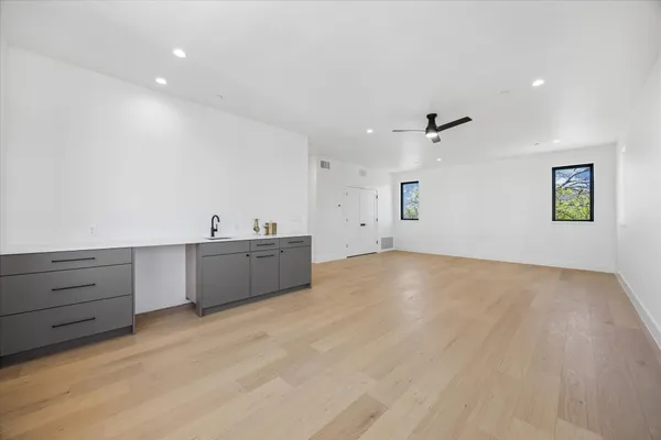 a spacious bathroom with a double vanity sink and mirror