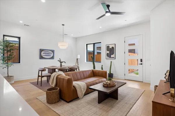 a living room with furniture and a potted plant