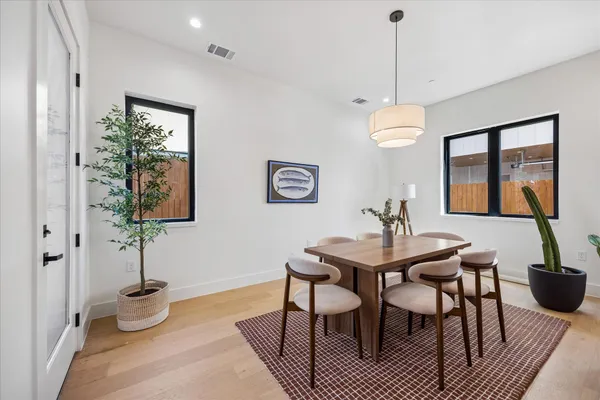 a view of a dining room with furniture and wooden floor