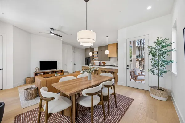 a kitchen with granite countertop a sink a counter space appliances and cabinets