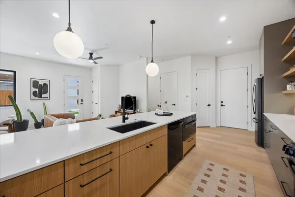 a kitchen with granite countertop a stove and a sink